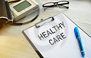 A tablet with a medical inscription. Medical desk with blood pressure monitor