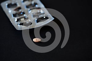 A tablet of medication on black background