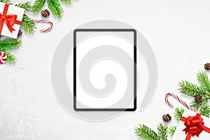 Tablet mockup on white desk with Christmas decorations