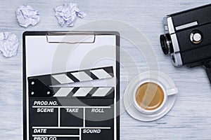 A tablet for a movie script and a cup of coffee on the director`s table photo