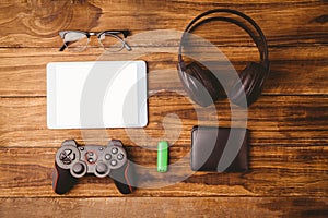 Tablet and music headphone next the joystick USB key and glasses