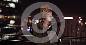 Tablet, night and balcony with a business black woman doing research while working outdoor at her office. Finance