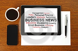 Tablet PC with business news, smart phone, paper, pen and cup of coffee