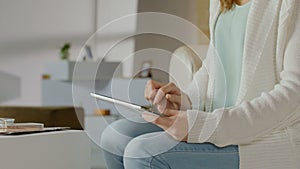 Tablet PC in female hands, woman reading, watching video on iPad