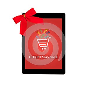 Tablet with red gift bow and christmas sale on a screen