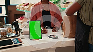 Tablet showing isolated greenscreen display at cash register