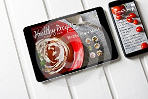 With tablet and smartphone healthy recipes blog on screen. Web o