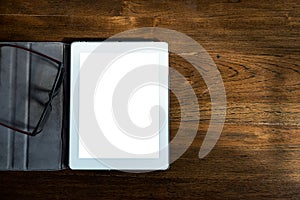 Tablet smartphone note paper and headphone set on wood table