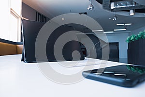 Tablet and smartphone on white table in room office