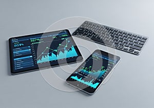 A tablet, smartphone, and wireless keyboard are arranged on a light