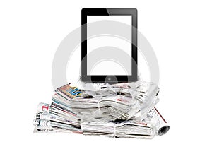 Tablet surrounded by huge amount of newspapers.