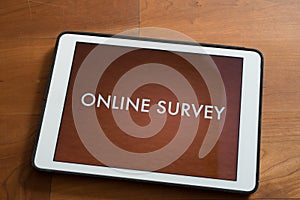 Tablet on table with online customer survey