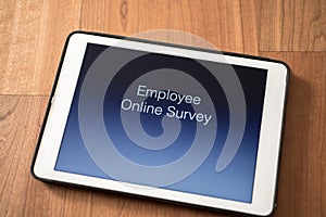 Tablet on table with online employee survey