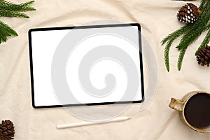 Tablet touchpad on white background with stylus pen, coffee cup pinecones and leaf