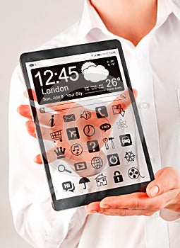 Tablet with transparent screen in human hands.