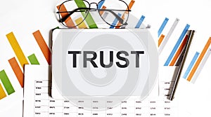 The tablet with TRUST on a chart