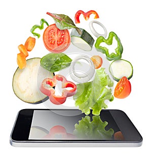 Tablet and vegetables isolated. Recipes application concept.