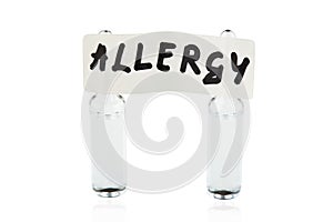 Tablet with written word ALLERGY stuck on two ampoules. Isolated