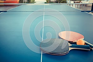 Tabletennis or ping pong rackets and balls on table. Sport concept