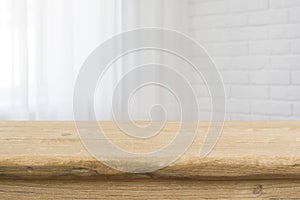 Tabletop on blurred curtained window and white brick wall background