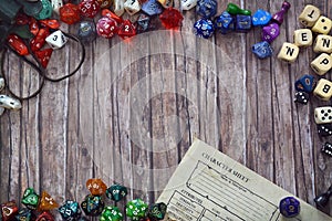 Tabletop role playing flat lay background with colorful RPG dices and character sheet