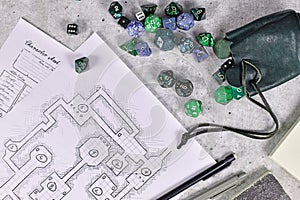 Tabletop role playing flat lay with RPG game dices, character sheet,dungeon map and pen