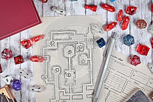 Tabletop role playing flat lay with RPG game dices, hand drawn character sheet, dungeon map and pen