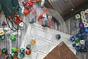Tabletop roleplaying flat lay with colorful RPG and game dices,  character sheet, rule book and treasure chest