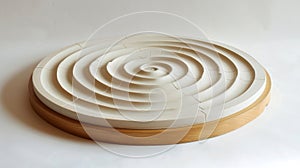 A tabletop wedging board with spiral grooves and measuring lines for preparing clay for throwing on the wheel. photo