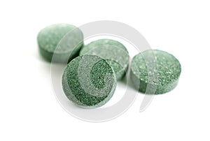 Tablets with Arthrospira or spirulina isolated on white background