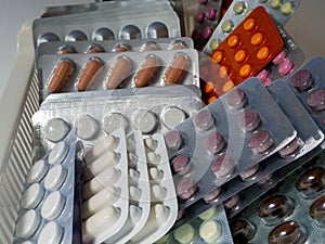 Tablets in blisters are neatly laid out on a shelf. Medical background with medicines for pharmacies, business photo