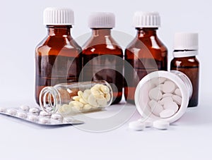 Tablets in a bottle on a background of medical bottles