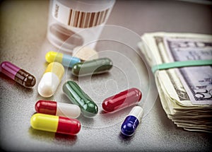 Tablets and capsules of various types next to banknotes American