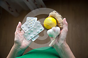 Tablets lemon garlic ginger in women`s hands