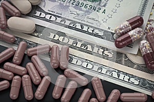 Tablets, pills, capsules on dollars background