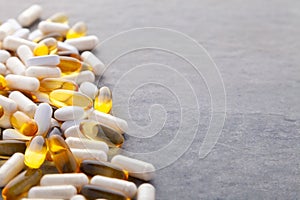 Tablets, pills, capsules, drugs pouring out of white bottle on white background. Sport, healthy lifestyle, medicine