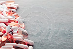 Tablets, pills, capsules, drugs pouring out of white bottle on white background. Sport, healthy lifestyle, medicine