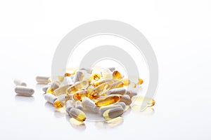 Tablets, pills, capsules, drugs pouring out of white bottle on white background. Sport, healthy lifestyle, medicine