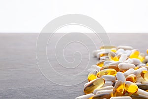 Tablets, pills, capsules, drugs pouring out of white bottle on white background. Sport, healthy lifestyle, medicine