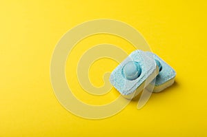 Tablets for softening water on a yellow background.