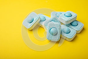 Tablets for softening water on a yellow background.