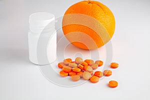 Tablets vitamin C and fresh juicy orange on white background. Vitamins from foods or supplements choices. Health and medical