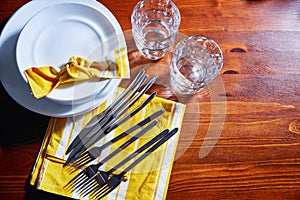 Tableware and decorations for serving a festive table. Plates, glasses and cutlery with decorative textile