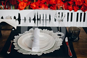 Tableware Glasses, flower fork, knife served for dinner in restaurant with cozy interior