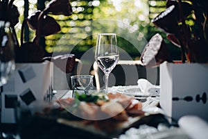 Tableware Glasses, flower fork, knife served for dinner in restaurant with cozy interior