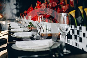 Tableware Glasses, flower fork, knife served for dinner in restaurant with cozy interior