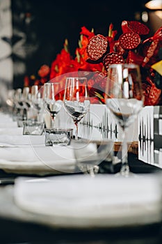 Tableware Glasses, flower fork, knife served for dinner in restaurant with cozy interior