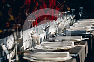 Tableware Glasses, flower fork, knife served for dinner in restaurant with cozy interior