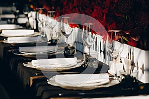 Tableware Glasses, flower fork, knife served for dinner in restaurant with cozy interior