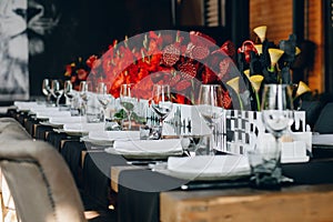 Tableware Glasses, flower fork, knife served for dinner in restaurant with cozy interior